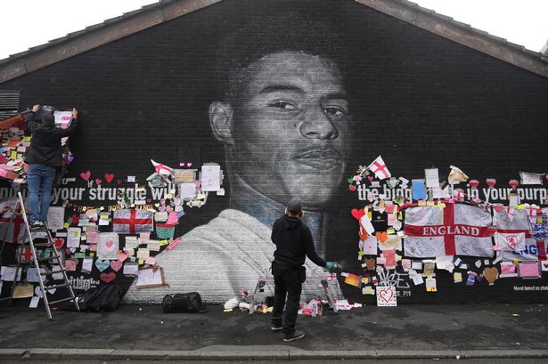 This image has an empty alt attribute; its file name is 0_Defaced-Mural-Of-Marcus-Rashford-Repaired-By-The-Artist-In-Manchester-1.jpeg
